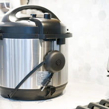 Cord wrapper on a pressure cooker